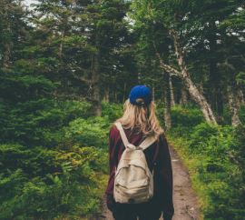 Woman hiking through CA forest