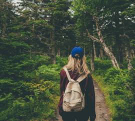 Woman hiking through CA forest